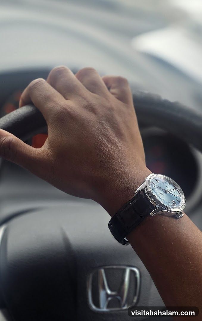 Person driving a car wearing a watch