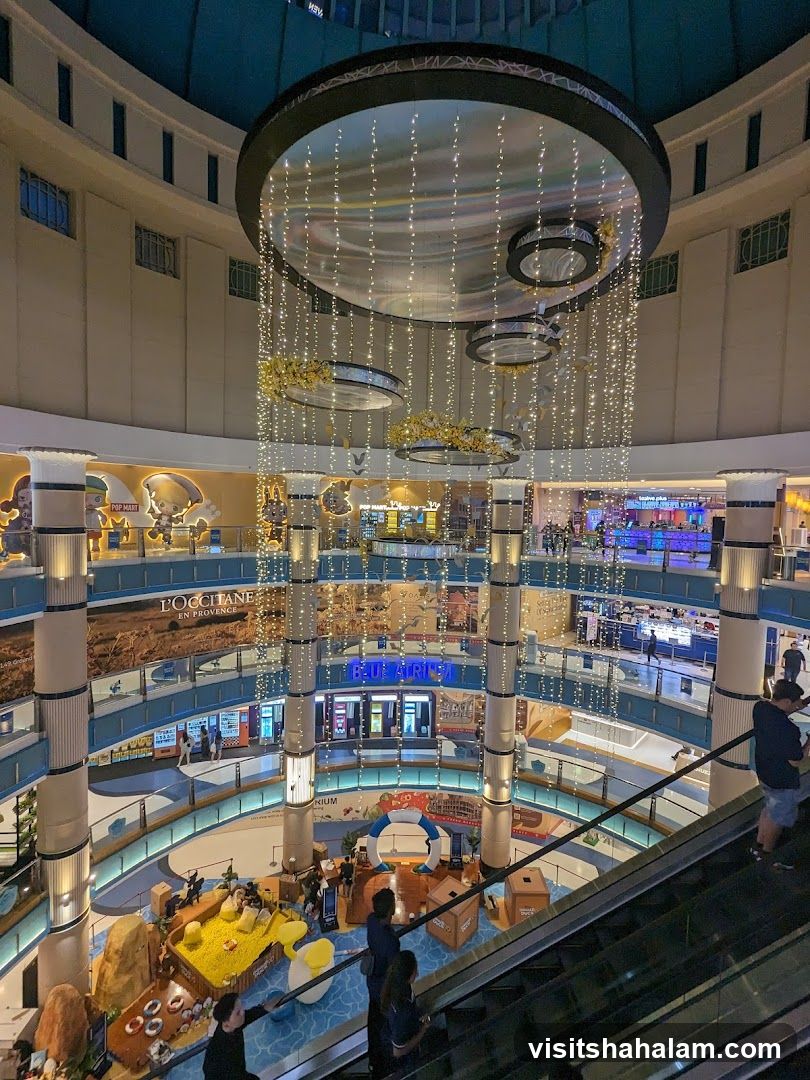 Interior of a multi-level shopping mall with a large central atrium