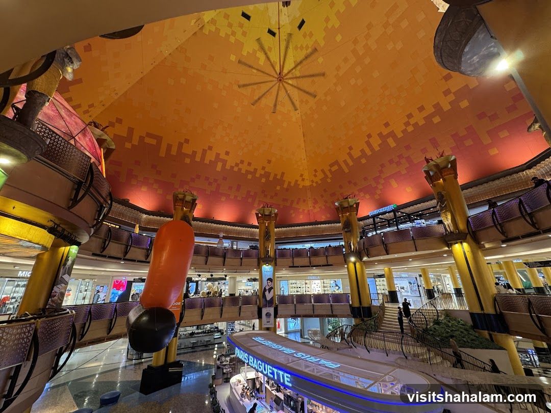 Interior of a shopping mall with a large orange inflatable sculpture