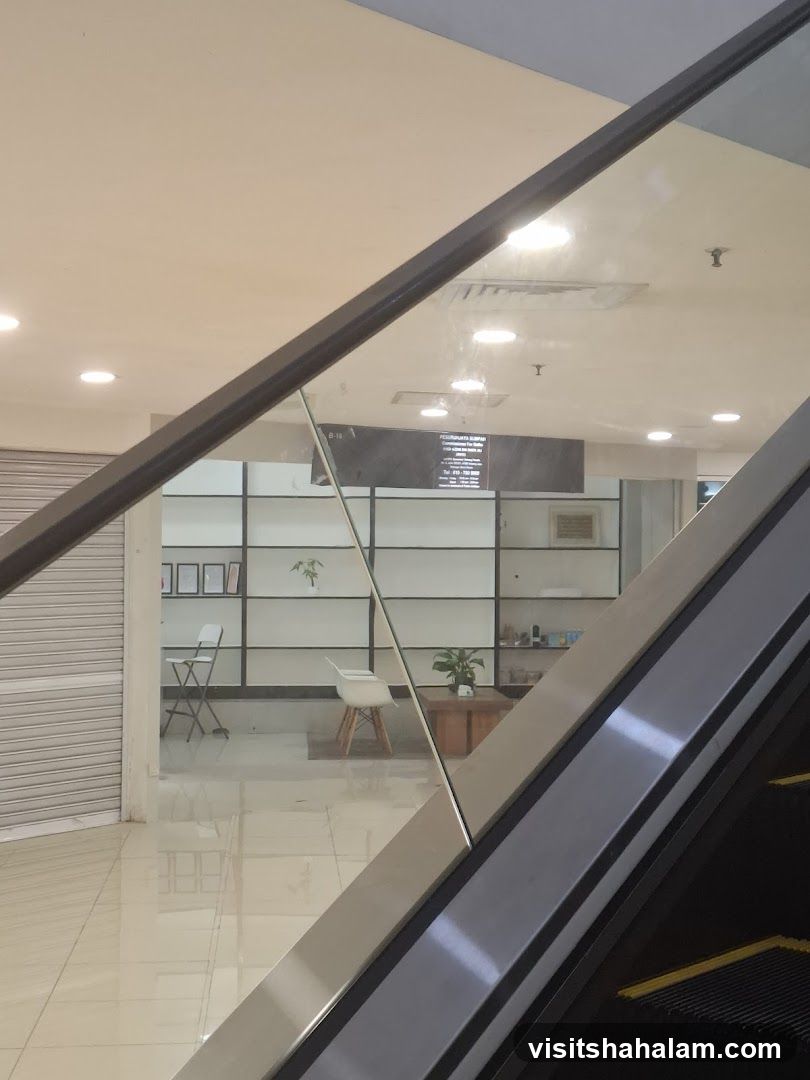 Interior of a building with an escalator and a shop