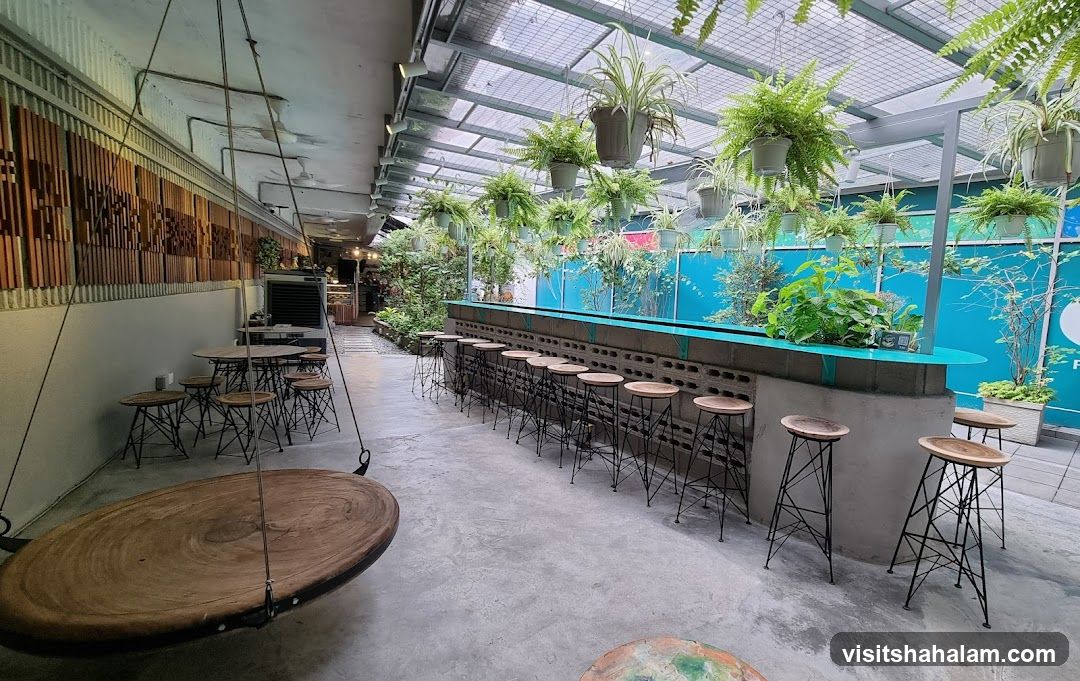 Indoor cafe with hanging plants and bar seating