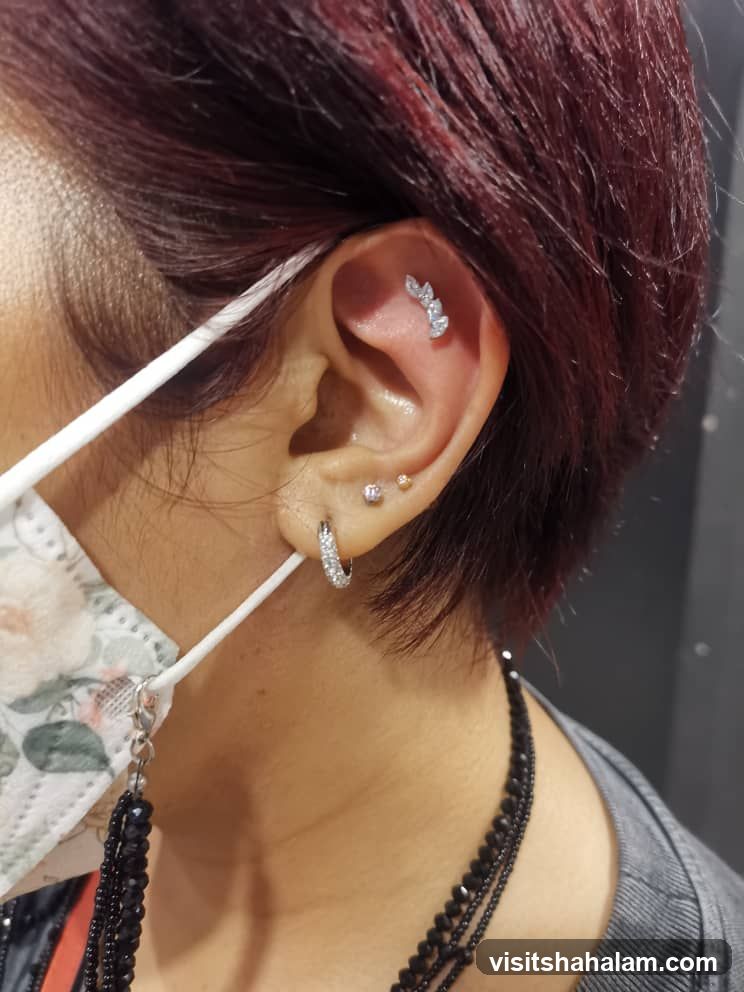 Close-up of ear with piercings and jewelry
