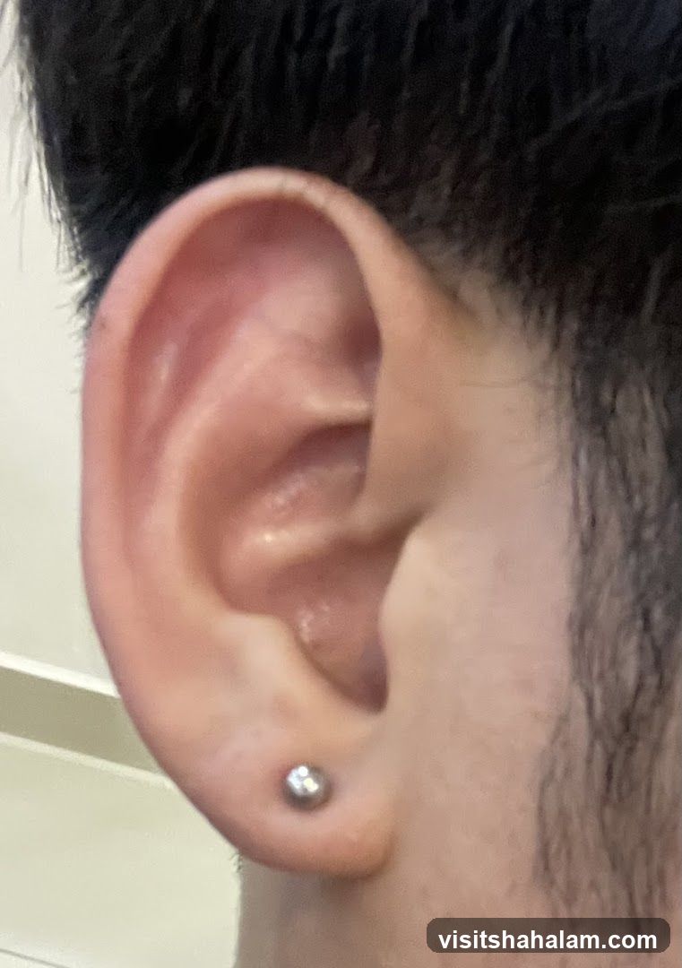 Close-up of a person's ear with a stud earring