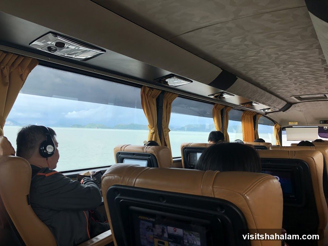 Passengers on a bus with a view of the sea