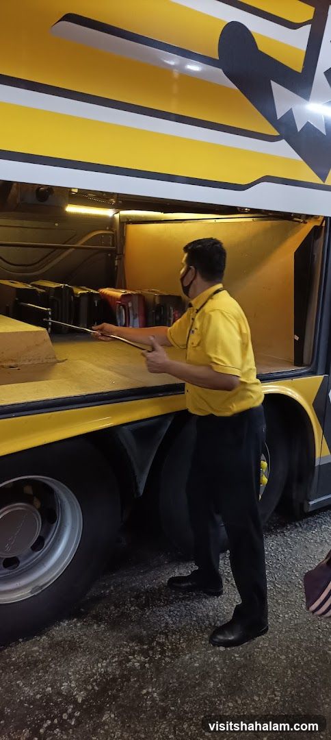 Man loading luggage into a bus