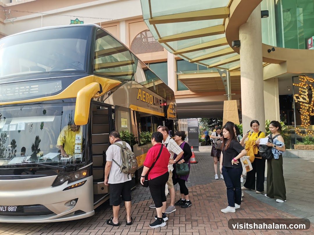 People waiting for a bus outside a mall