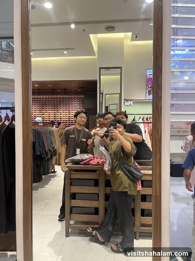 Group taking a mirror selfie in a clothing store