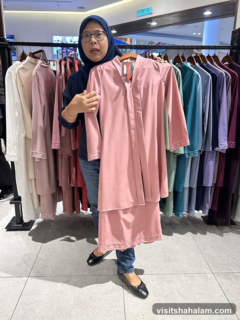 Woman holding a pink outfit in a clothing store