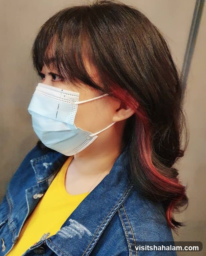 Woman with dark hair and red highlights
