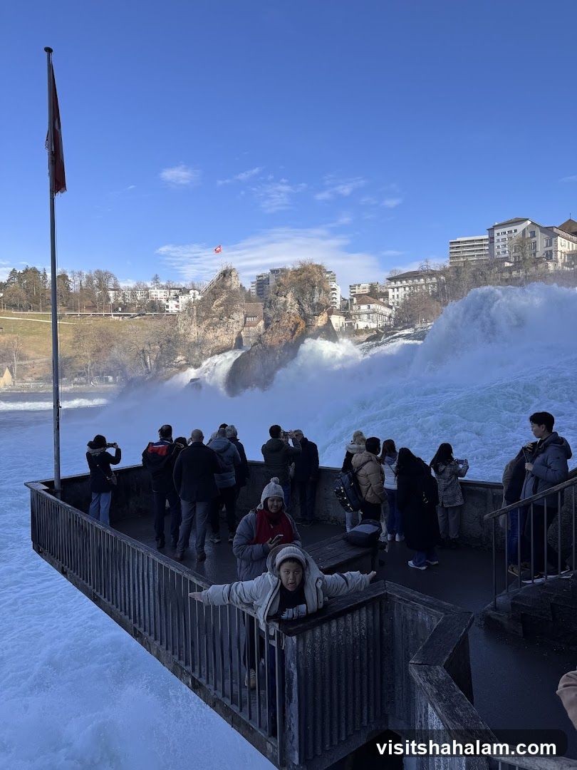 Tourists at a Waterfall Viewing Platform