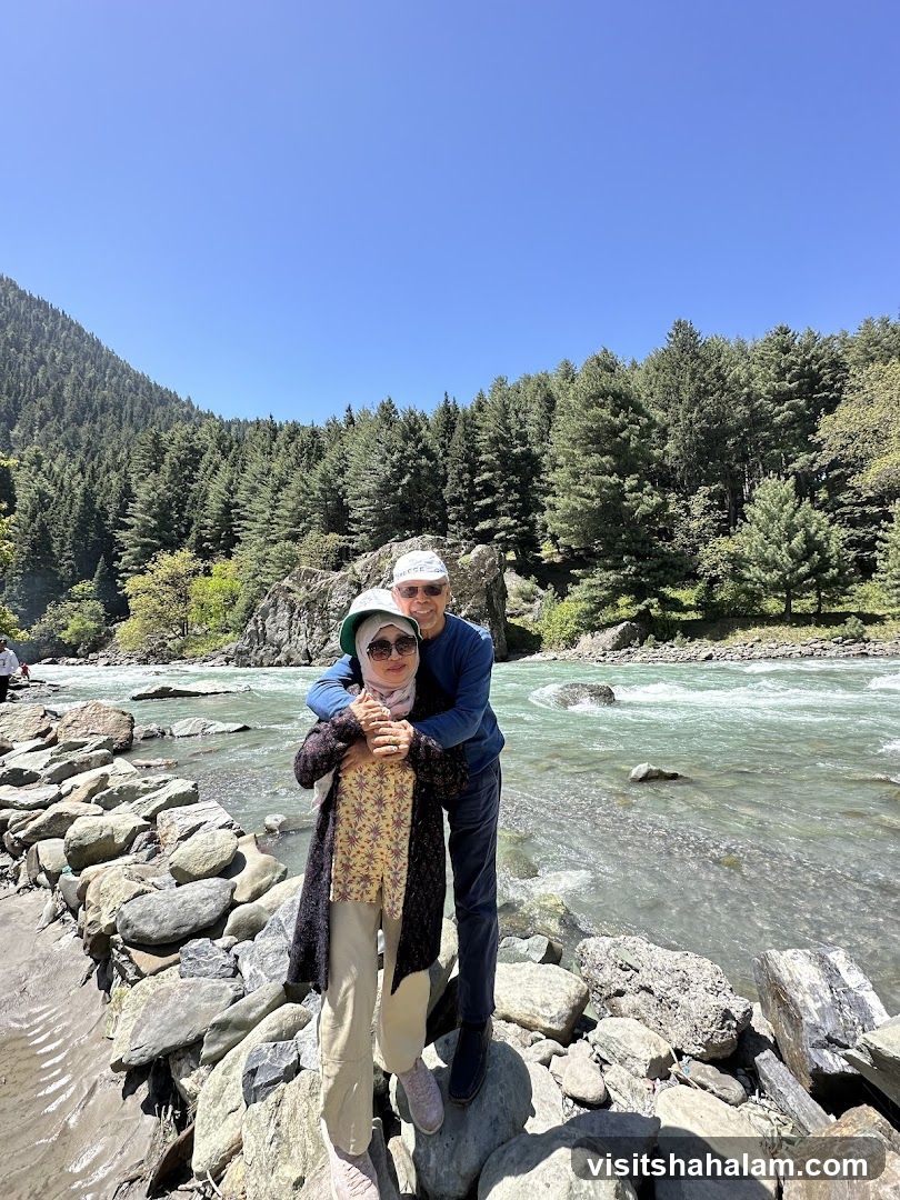 Couple posing by a river