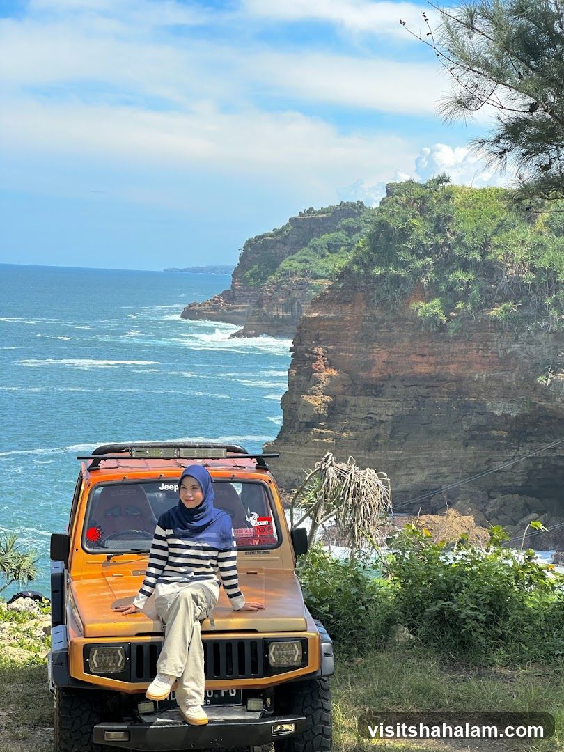 Woman Posing on a Jeep by the Ocean
