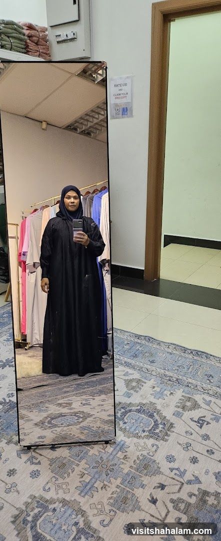 Woman in Abaya Reflected in Mirror