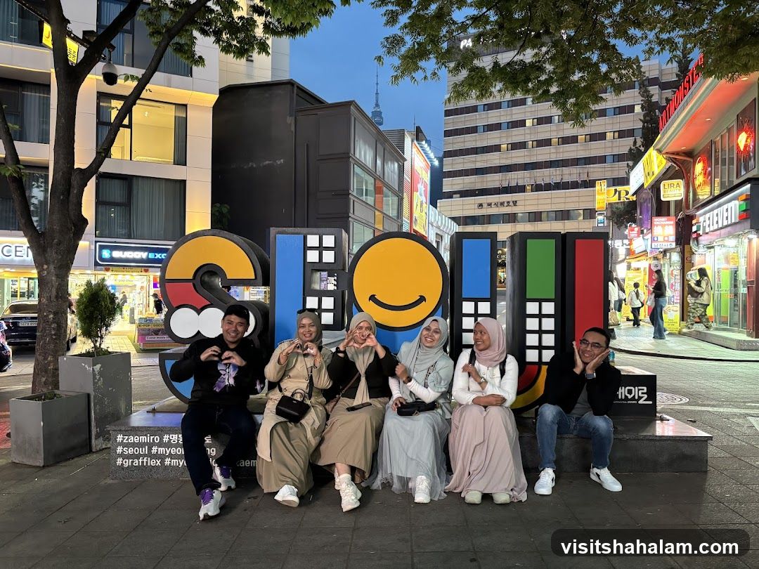 People Posing by a Large Sculpture