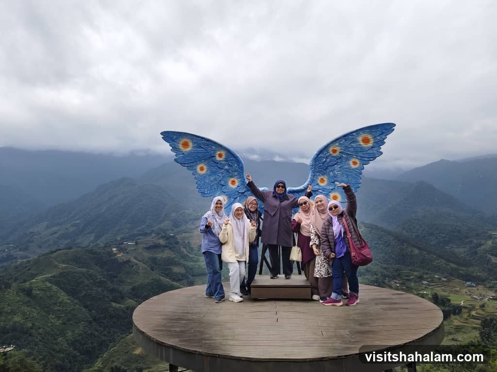 Group Poses with Butterfly Wings Sculpture