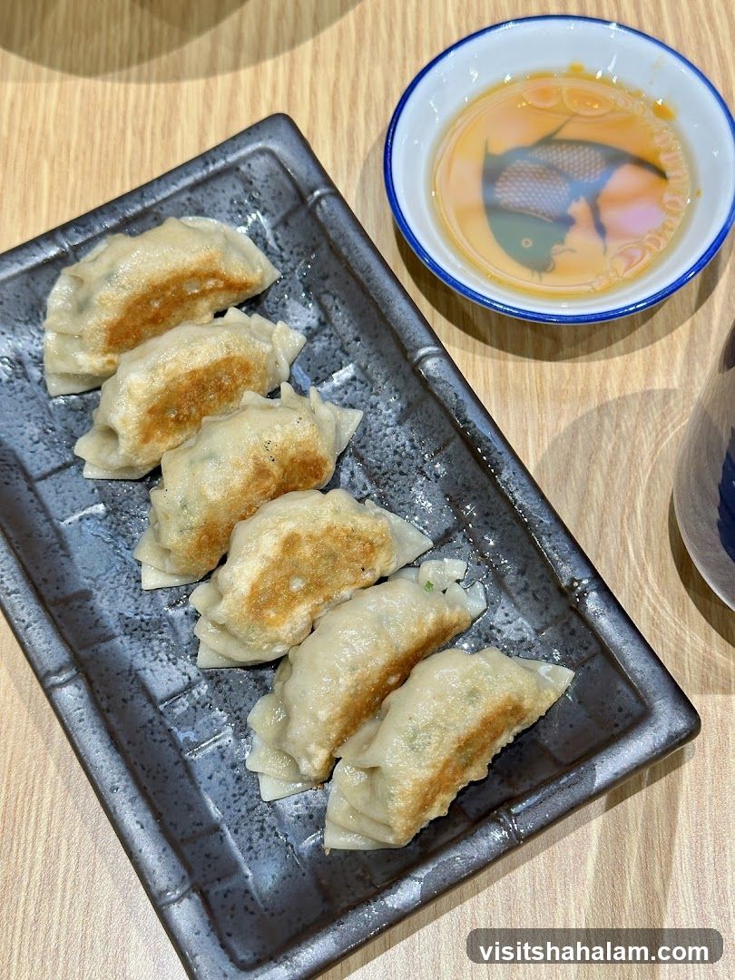 Pan-fried dumplings with dipping sauce