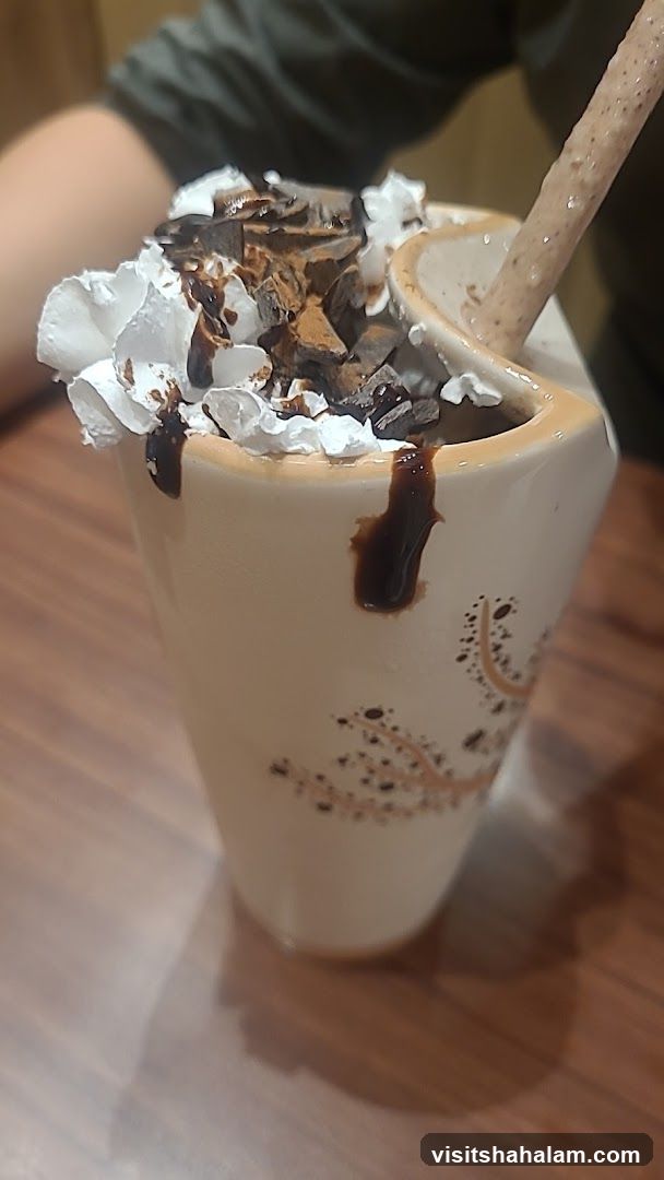 Chocolate milkshake with whipped cream and chocolate shavings