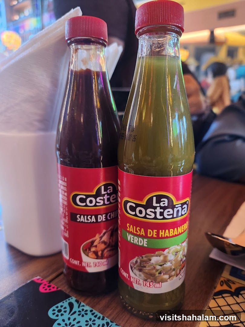 Two bottles of La Costeña salsa