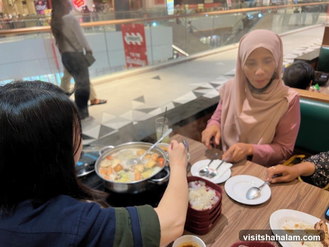 People eating hot pot in a mall