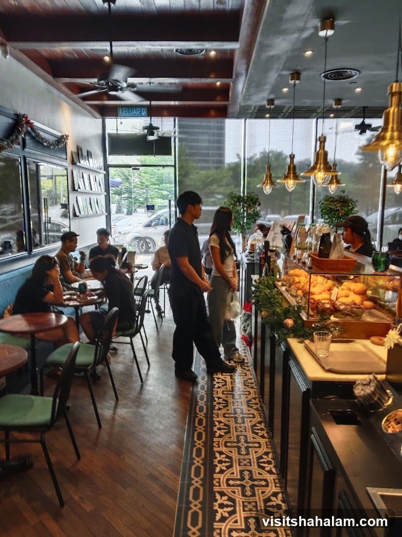 Interior of a cafe with customers and a display counter