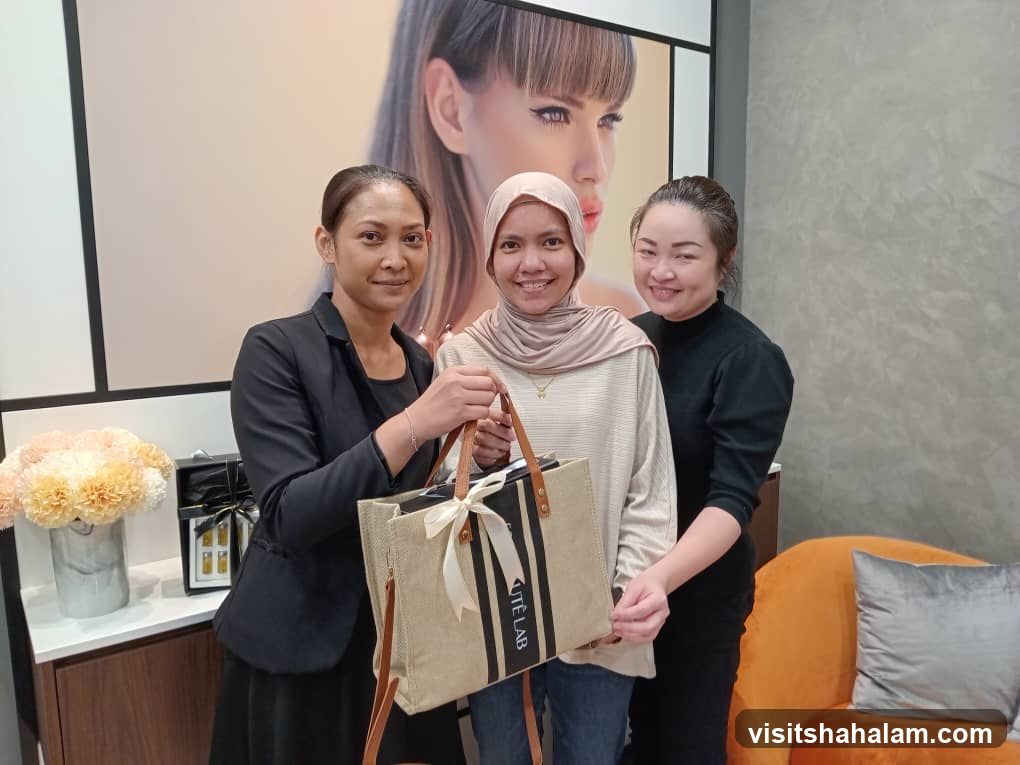 Three Women Posing with a Tote Bag