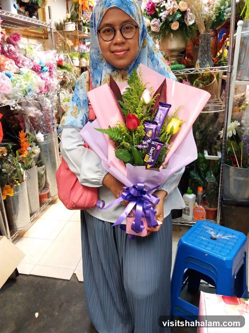 Woman holding a bouquet of flowers and chocolates