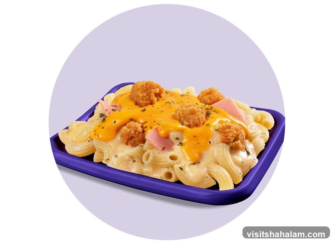 Macaroni with cheese sauce and fried chicken bites