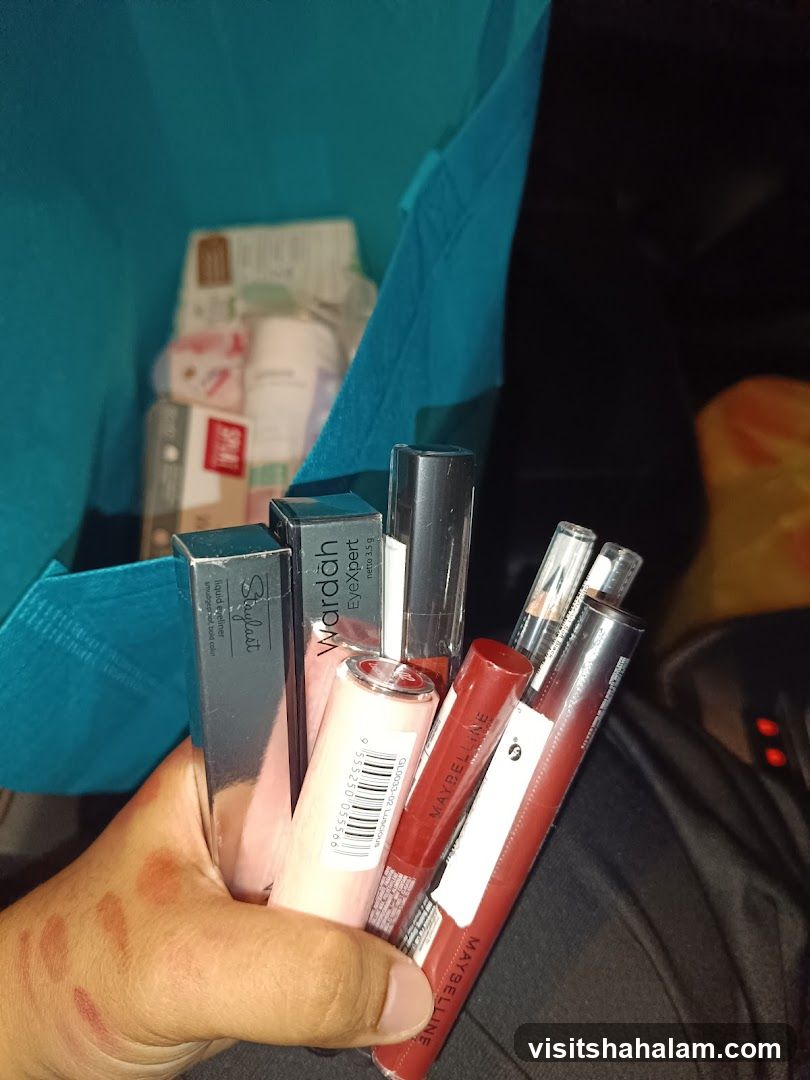 Hand holding makeup products
