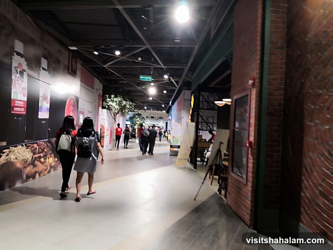 Indoor walkway with people and displays