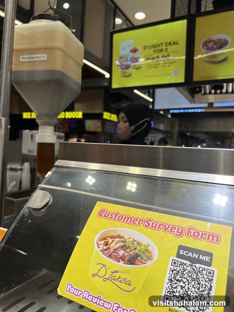 Food stall with prawn paste dispenser and promotional sign