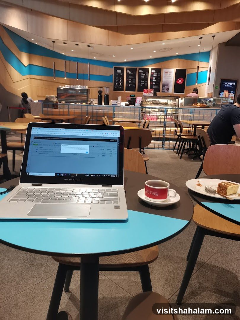Coffee Shop Interior with Laptop and Cake