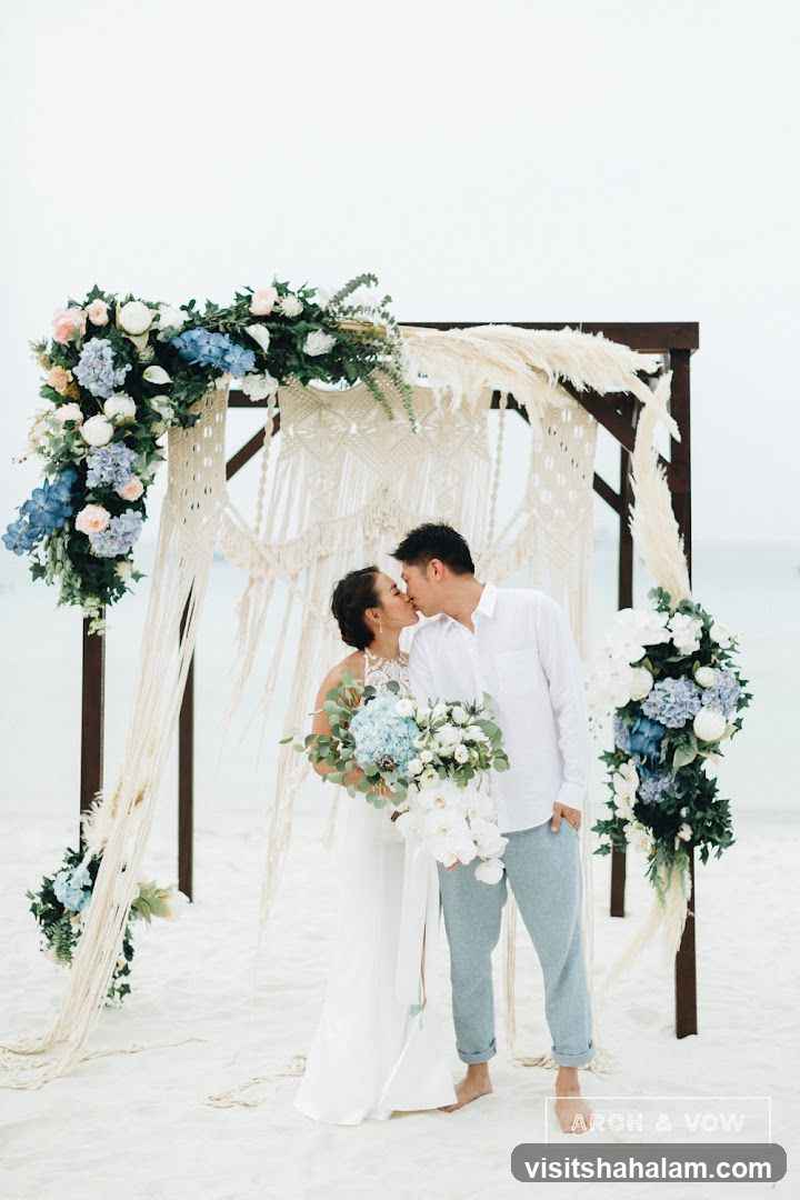 Wedding Couple Kissing Under Arch