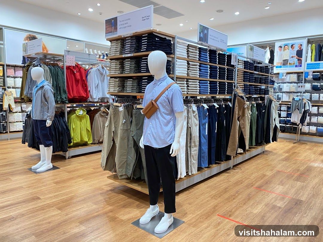 Clothing store interior with mannequins and folded clothes
