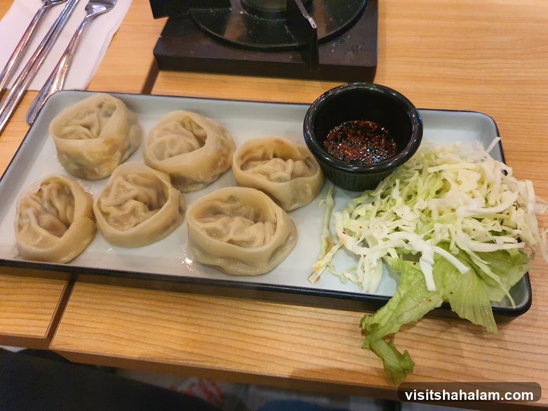 Steamed Dumplings with Shredded Cabbage and Dipping Sauce