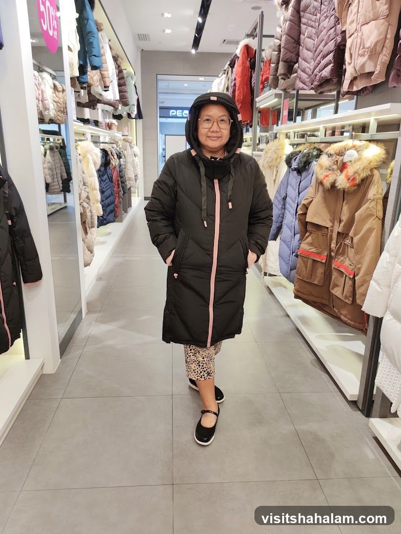Woman in a Puffer Coat in a Clothing Store