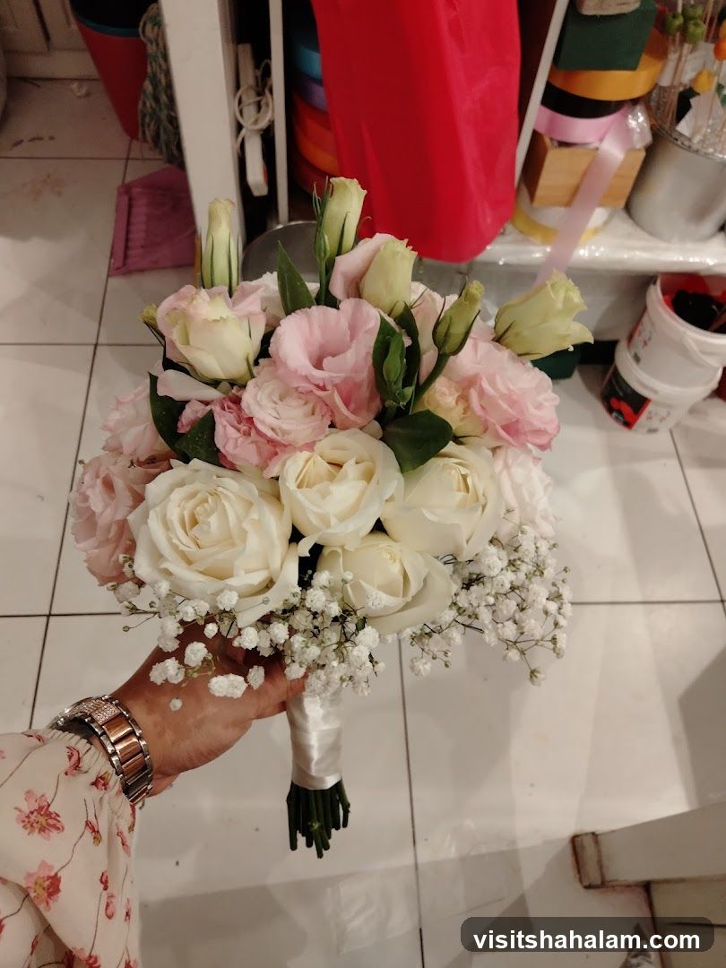 Hand holding a bridal bouquet