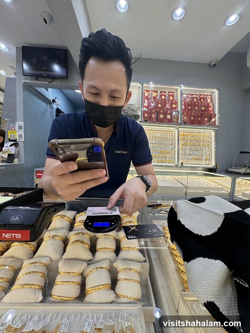 Man weighing gold jewelry