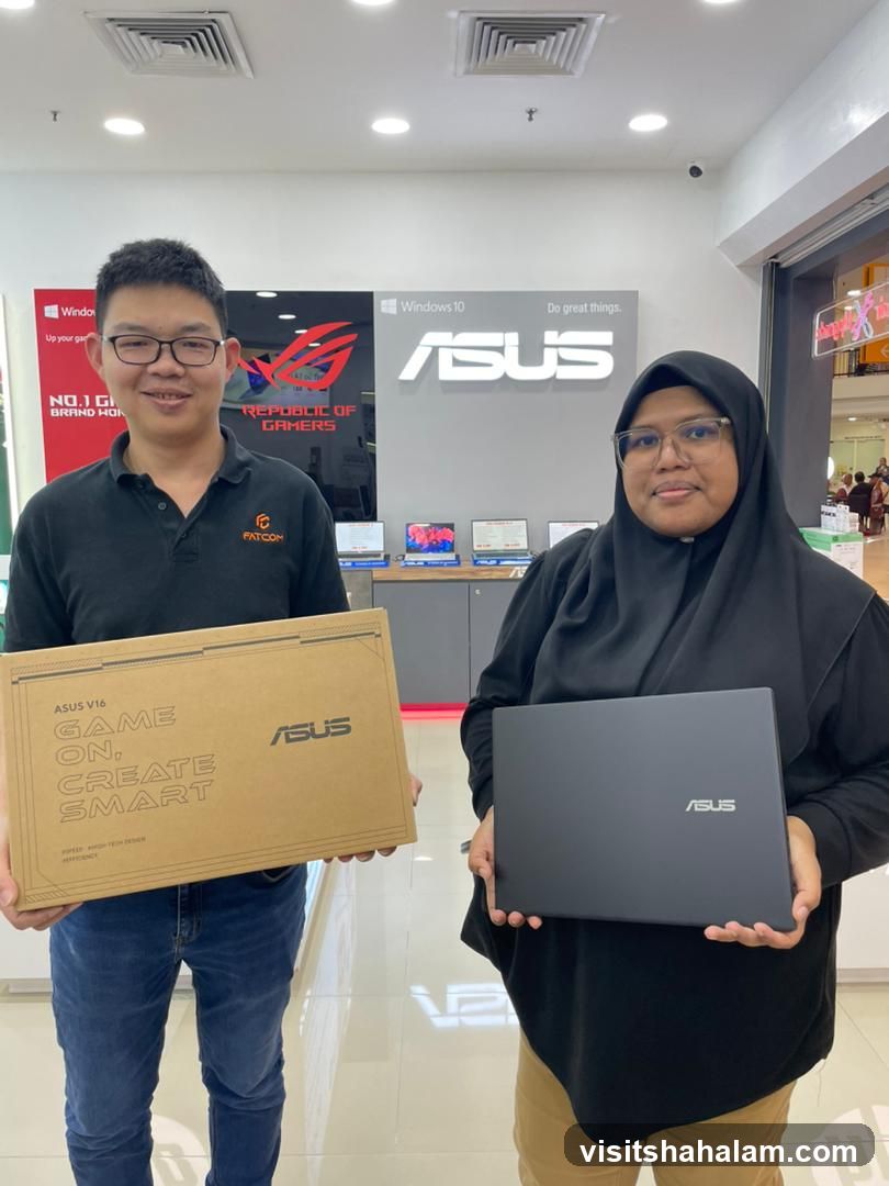 Two people holding ASUS products
