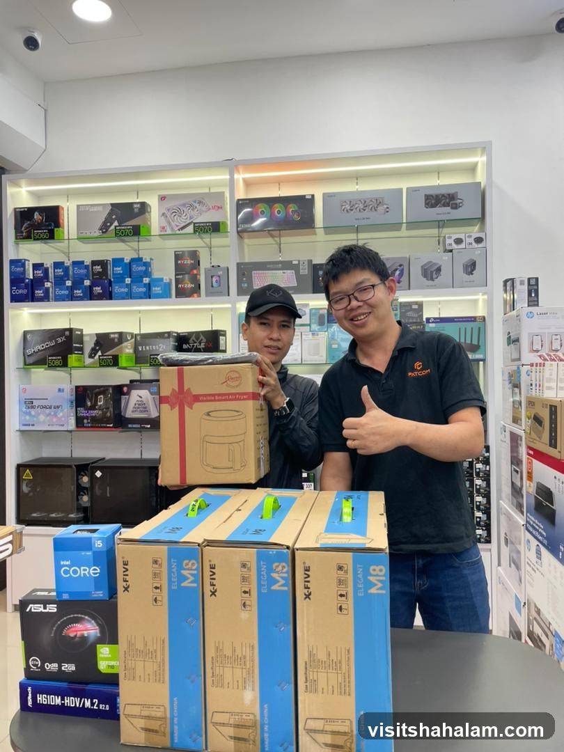 Two men holding boxes in a store