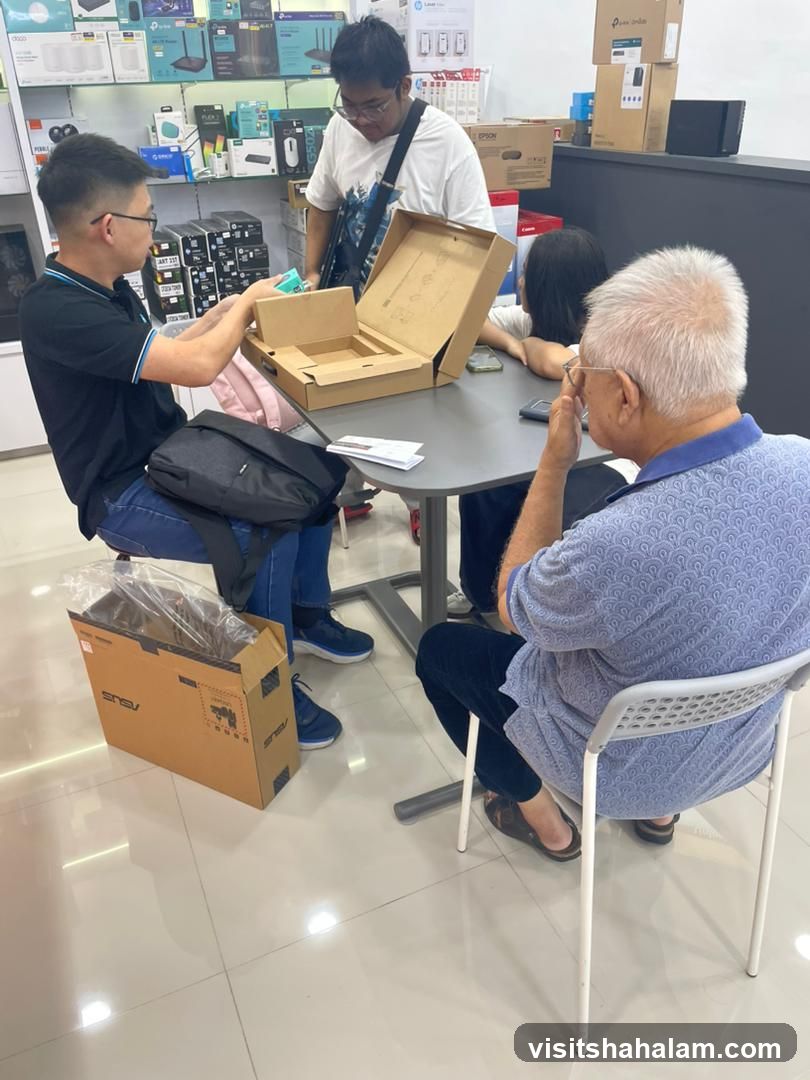 People unpacking a laptop