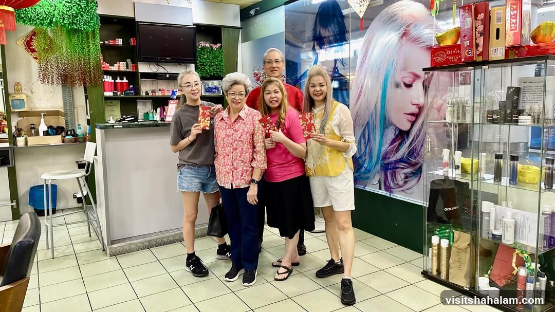 People holding red envelopes inside a salon