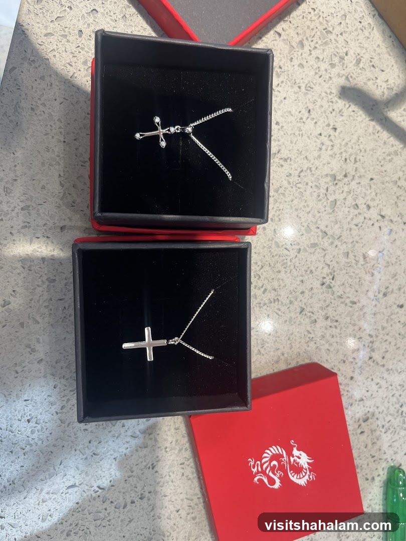 Two cross necklaces in boxes