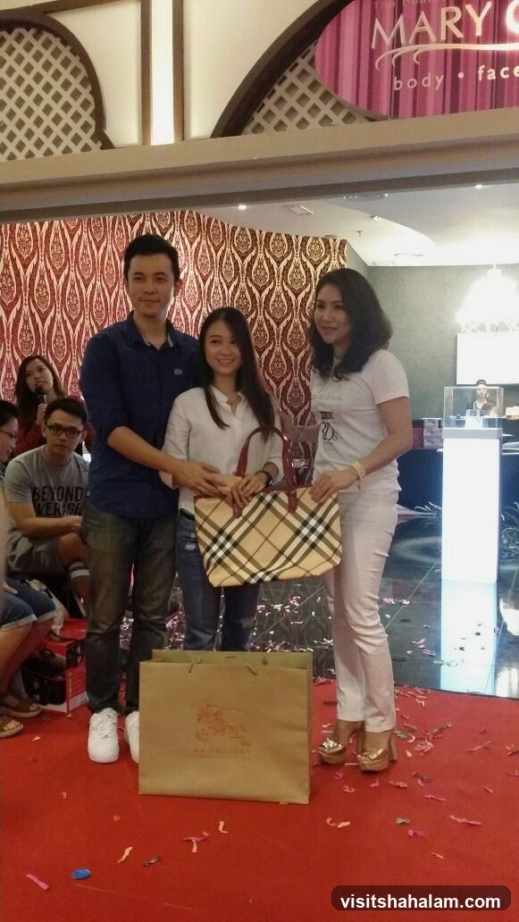 People posing with a handbag and shopping bag