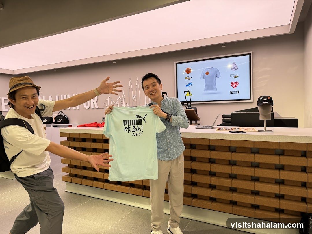 Two men in a store holding a t-shirt