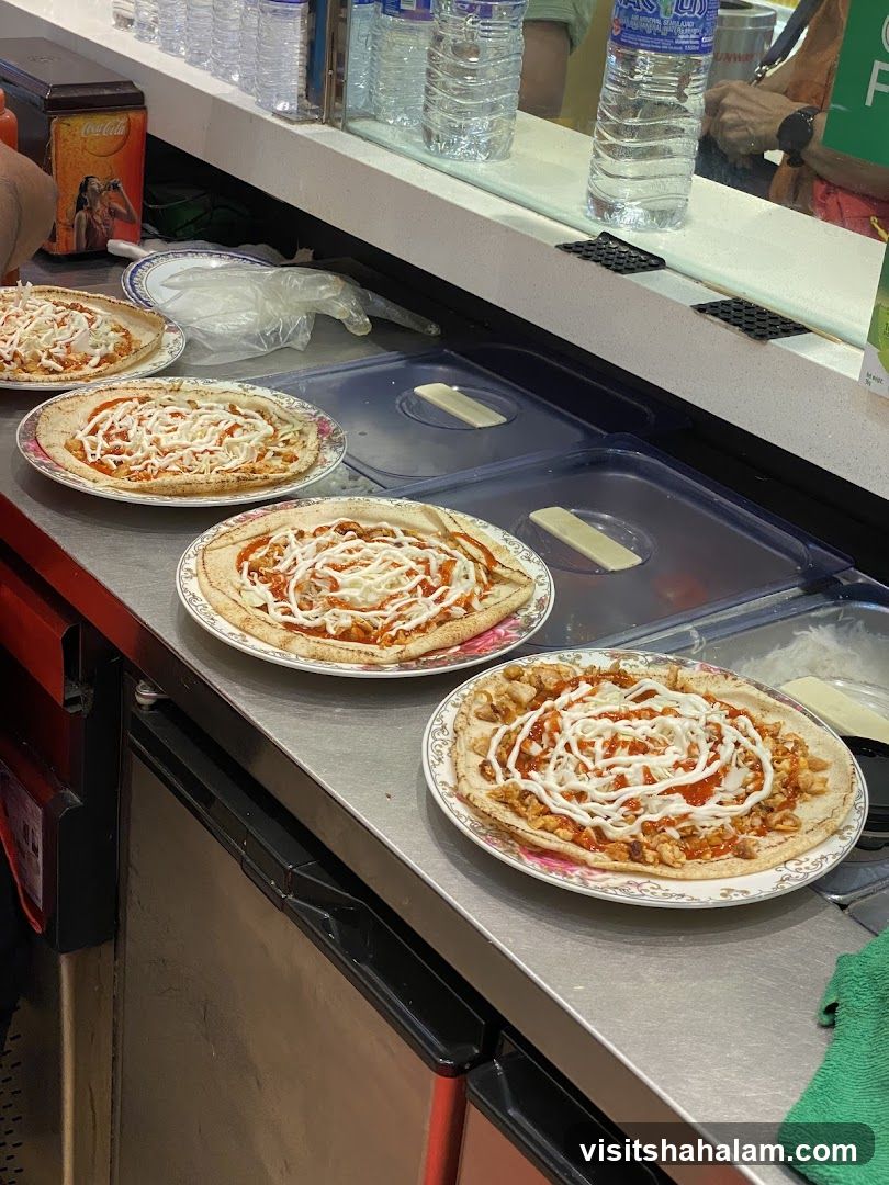 Pizzas being prepared