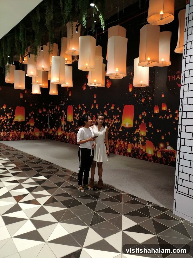 Two women standing in a decorated hallway