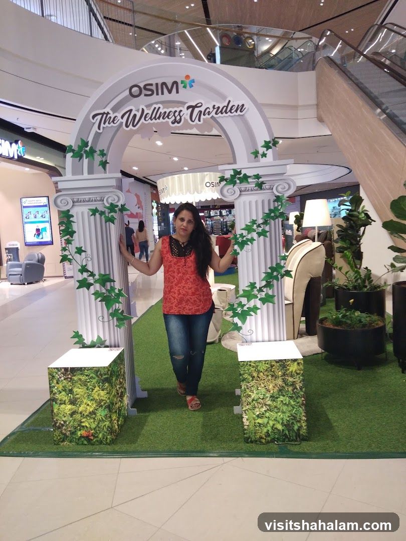 Woman posing in front of OSIM The Wellness Garden display
