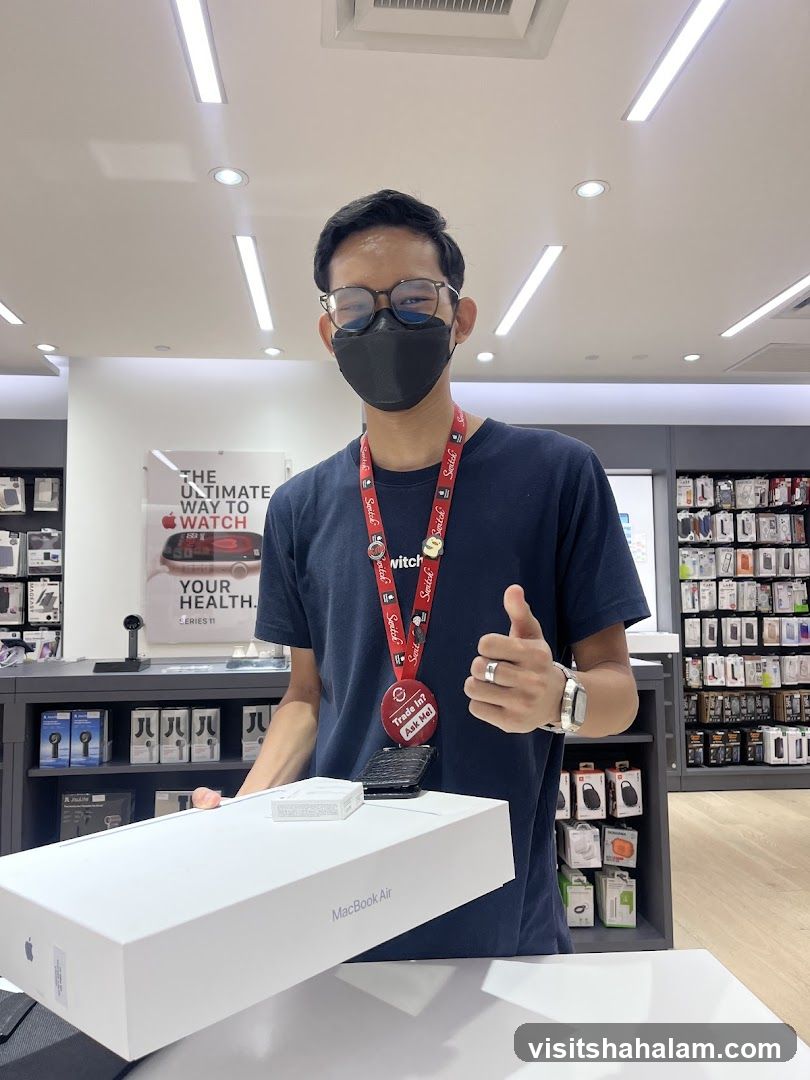 Salesperson with MacBook Air Box