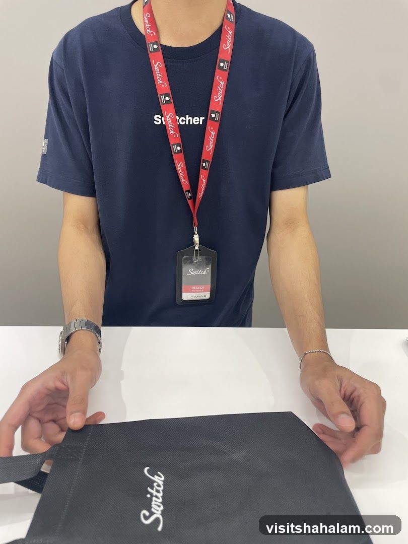 Employee with branded lanyard and bag