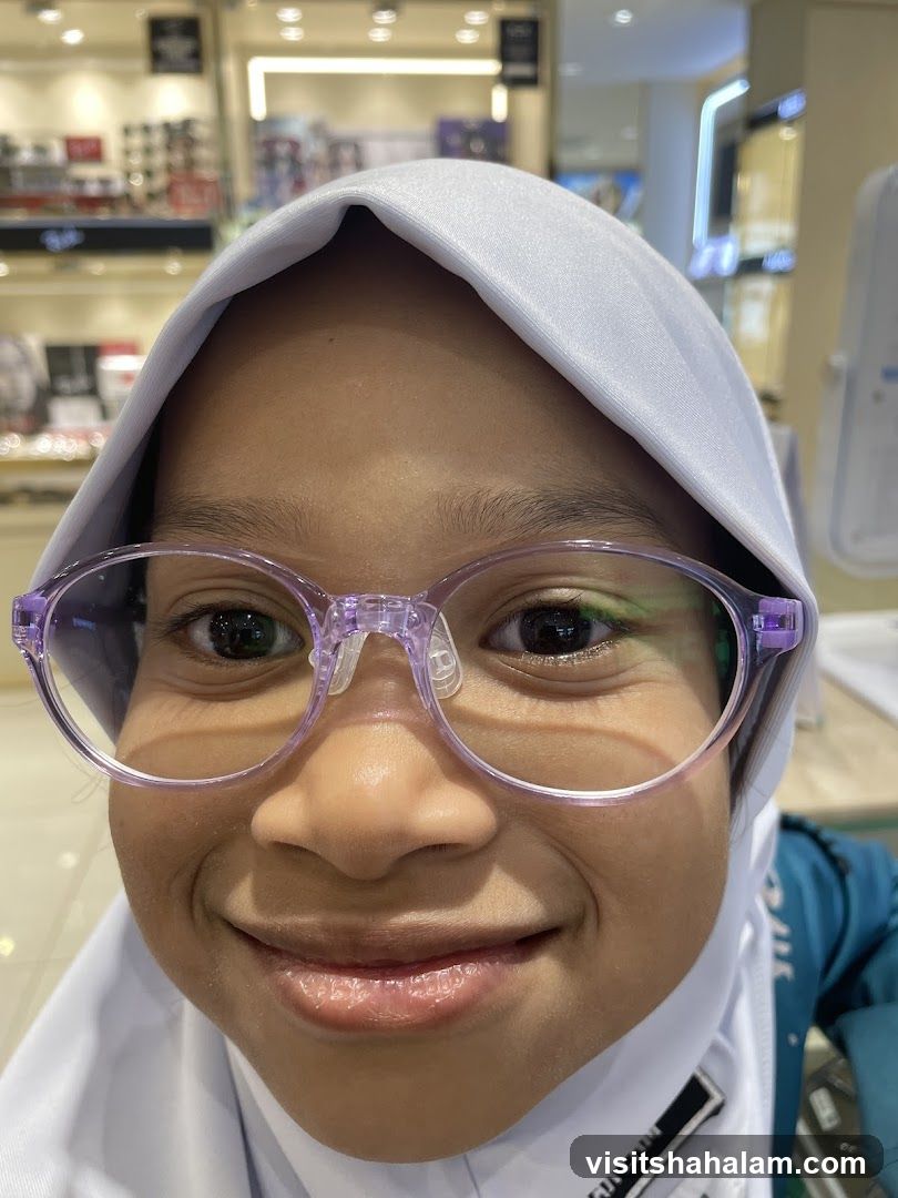 Young girl trying on glasses